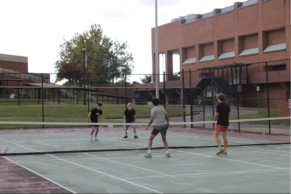 This image shows four members, from left to right, Matthew Gavin, Eli Lipscomb, Rishi Reddy, and Newton Raff playing an intense match.